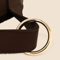 Load image into Gallery viewer, Close up of gold D-ring and leather trim detail on brown adjustable dog harness