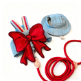 Load image into Gallery viewer, GraviPaw denim cat harness with oversized red bow and matching red leash flatlay product photo