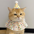 Load image into Gallery viewer, Cat wearing a colorful polka dot party hat and collar on a plain background