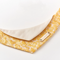 Load image into Gallery viewer, Close-up of woven gold floral jacquard fabric and personalized engraved gold-tone name plate on pet bandana