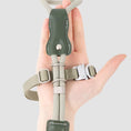 Load image into Gallery viewer, Hand holding green leather cat harness showing adjustable metal buckle and soft strap close up
