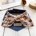Load image into Gallery viewer, Top view of circus-themed bow pet collar with snap-button closure and denim base
