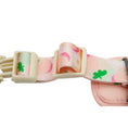 Load image into Gallery viewer, Close-up of adjustable buckle and peach print strap on pink dog harness
