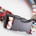 Load image into Gallery viewer, Close-up of anti-burst safety buckle on floral reflective dog harness
