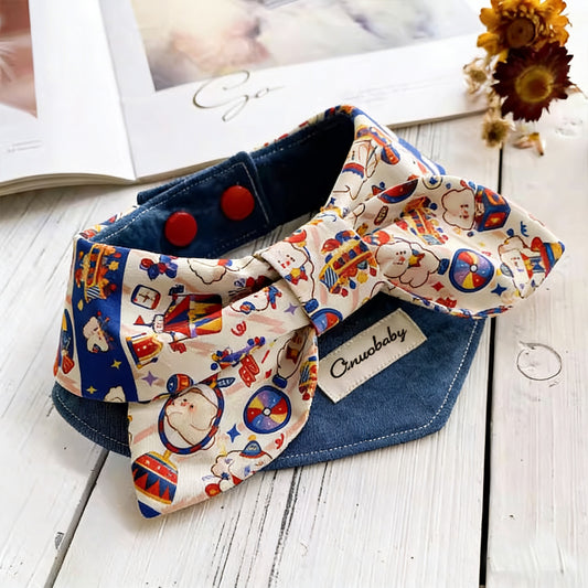 Cute circus print bow pet collar with denim base styled on white wooden surface