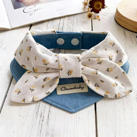 Cream floral print bow pet collar with blue denim bandana styled on wooden surface