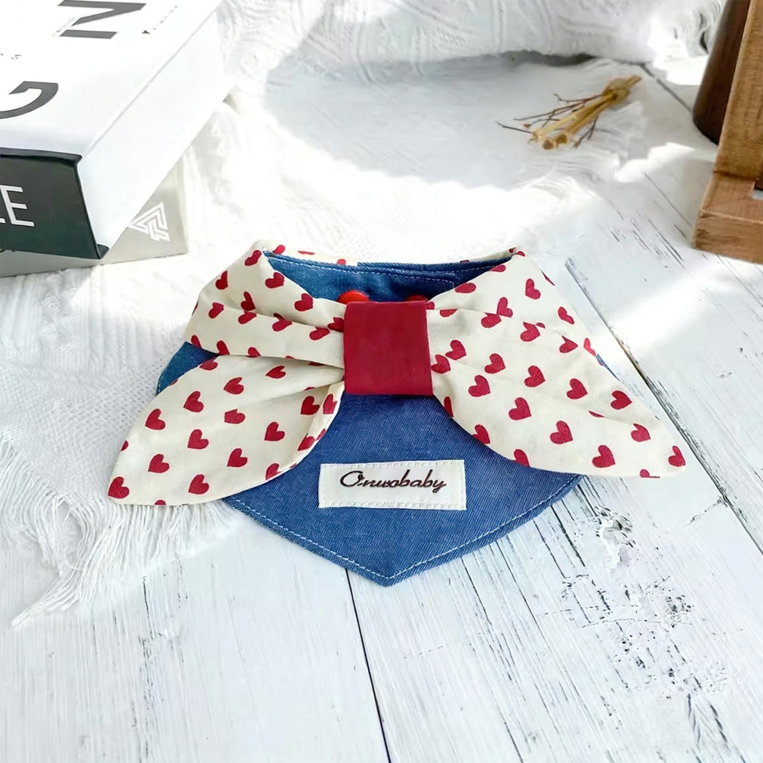 Cute denim heart bow pet collar styled on white wooden surface for Valentine's Day