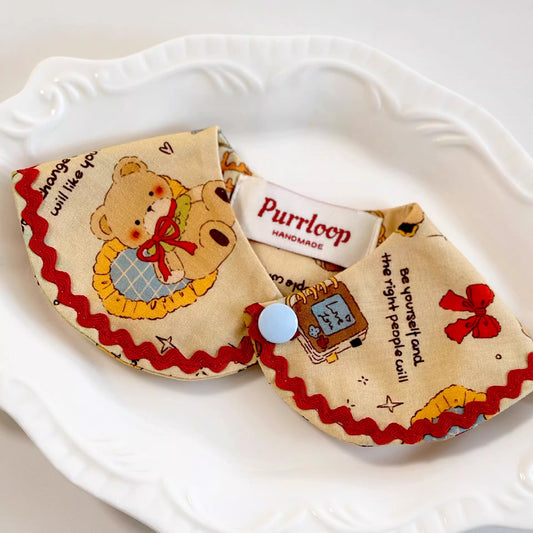 Vintage teddy bear print pet collar with red trim styled on white plate