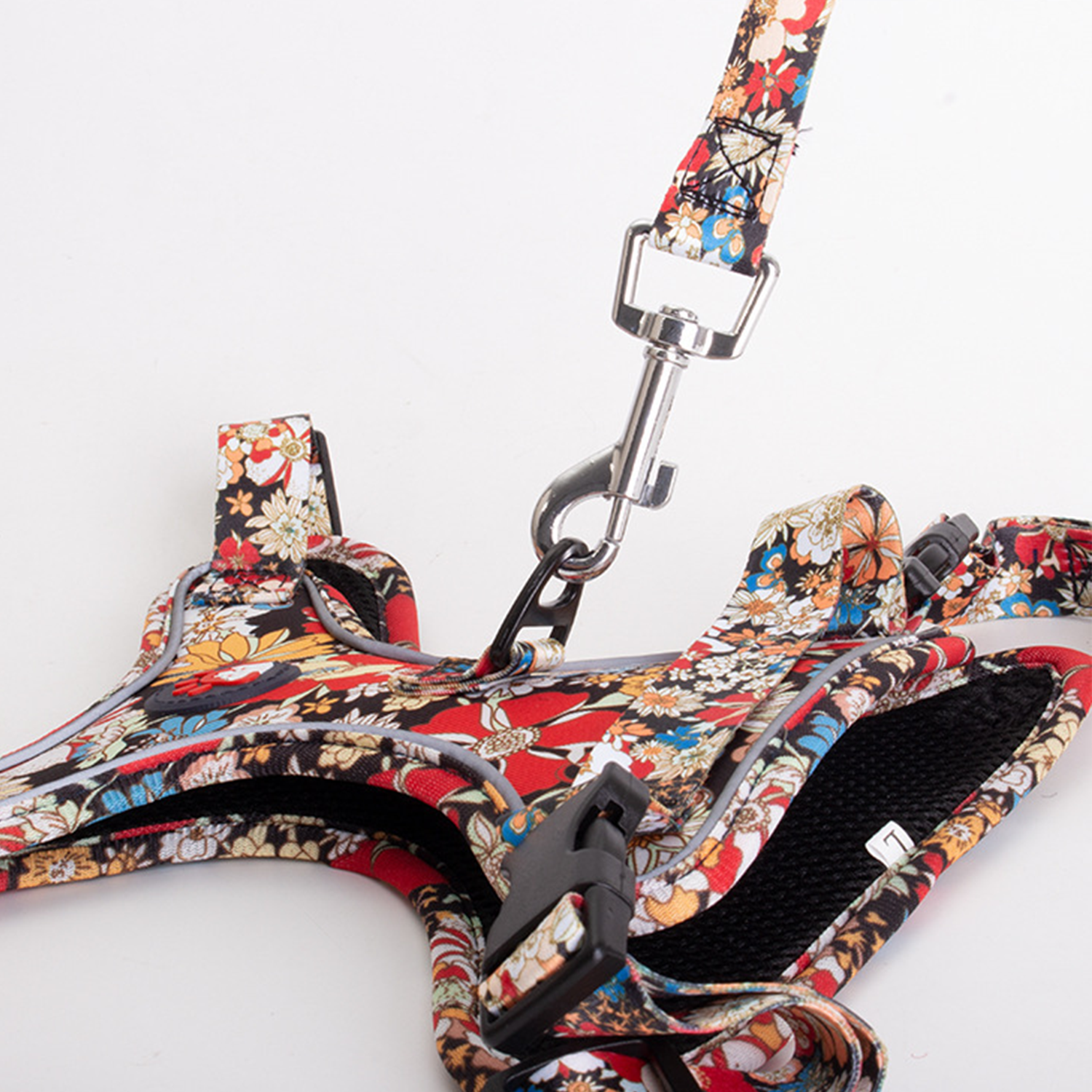Side view of floral reflective dog harness with matching leash attached