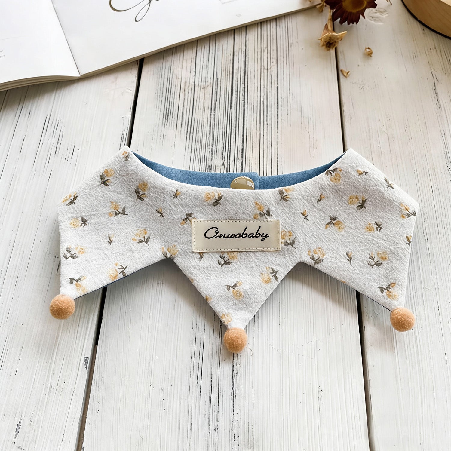 Flat lay of floral pattern reversible pet bandana with wooden bead trim