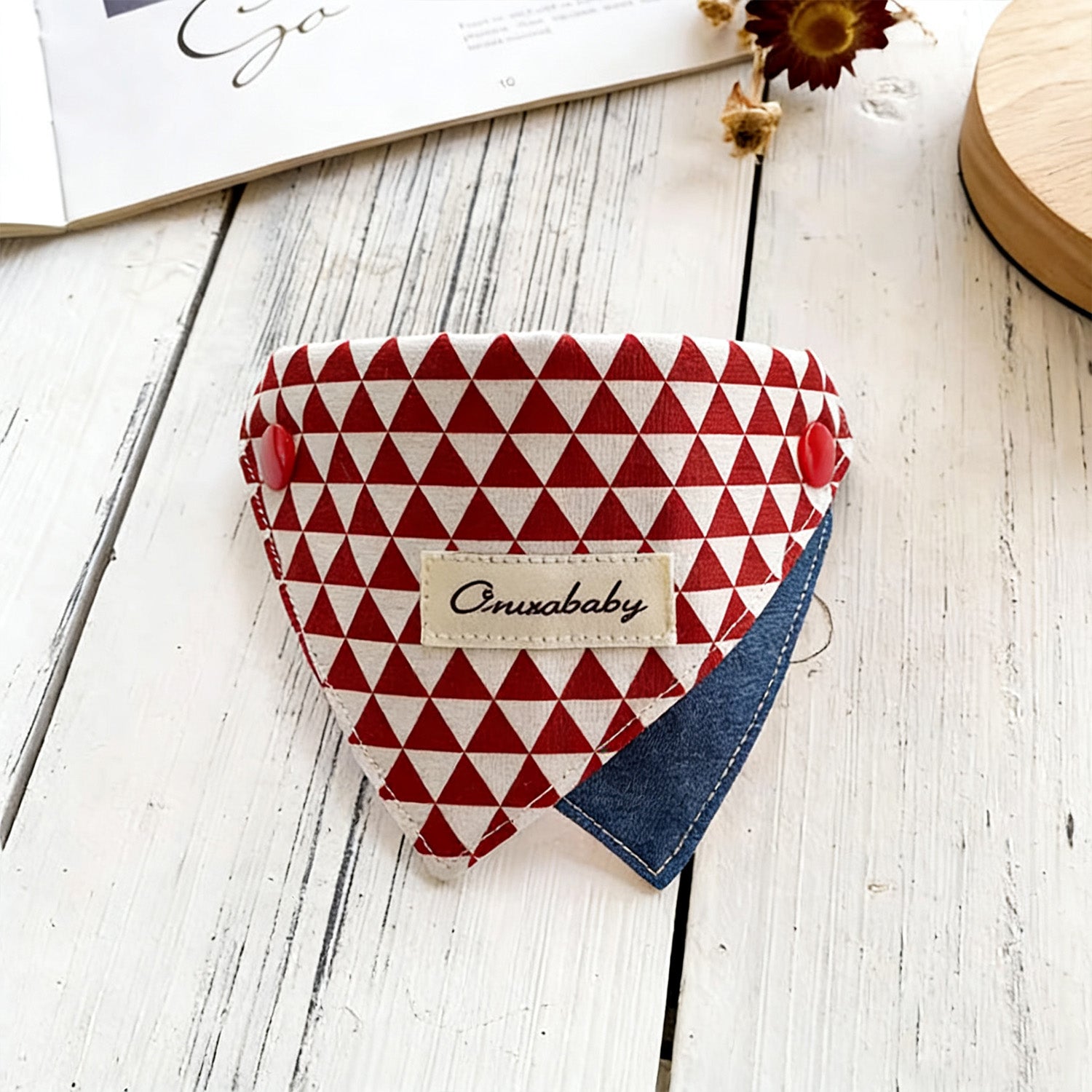 Geometric diamond pattern triangle pet bandana collar styled on wooden surface