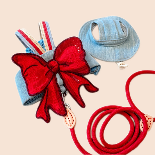 GraviPaw red bow denim cat harness set with matching red leash and denim cat hat on beige background