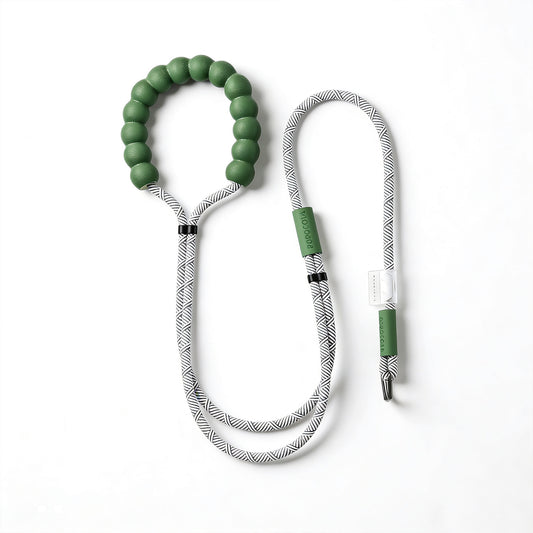 Full view of green adjustable puppy rope leash on white background