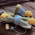 Load image into Gallery viewer, Green plush bow bandana with yellow star accents and elastic loop flat lay close up on neutral background
