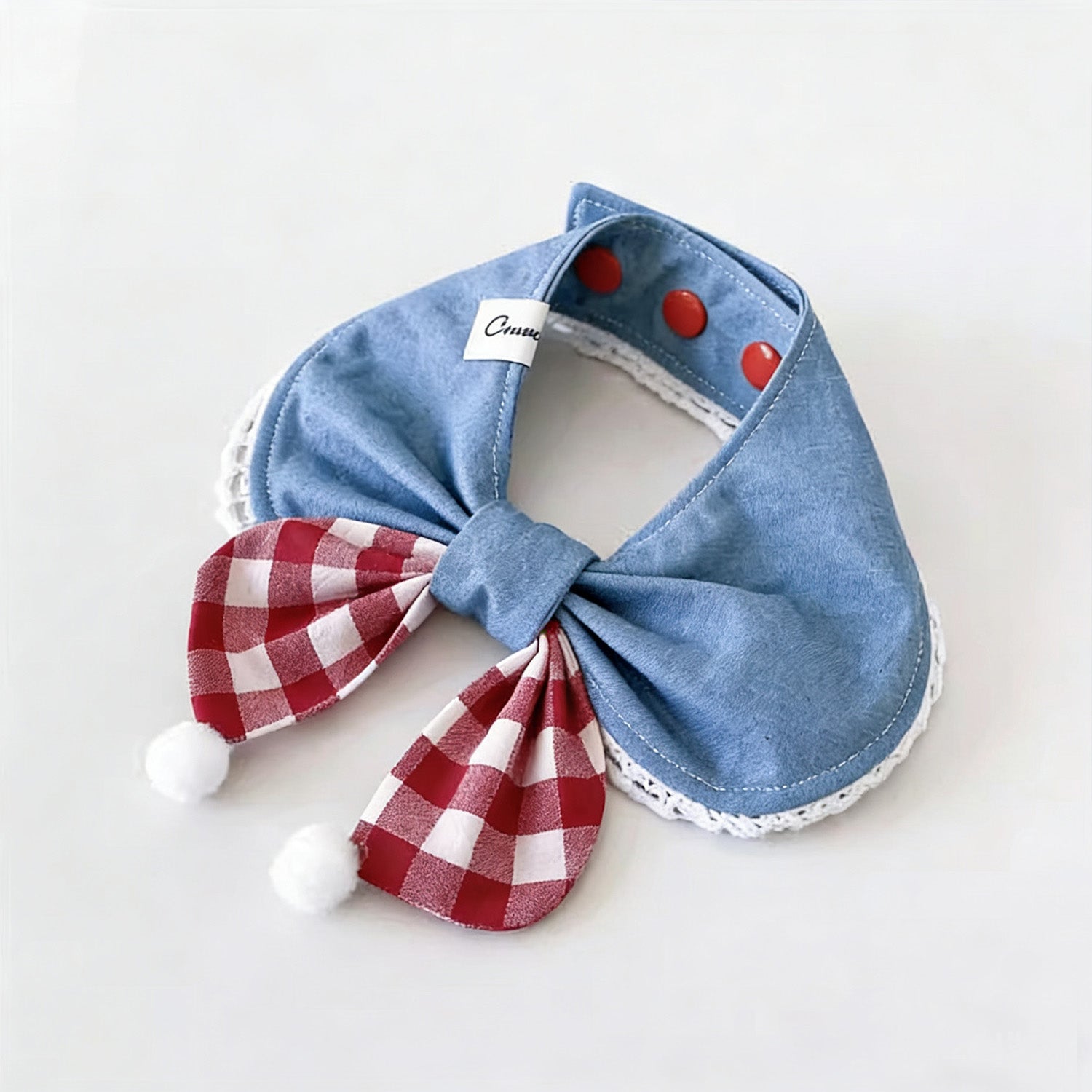 Blue denim pet collar with red gingham bow and white pom-pom detail