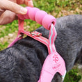 Load image into Gallery viewer, Hand gripping padded pink handle of stylish dog harness for control
