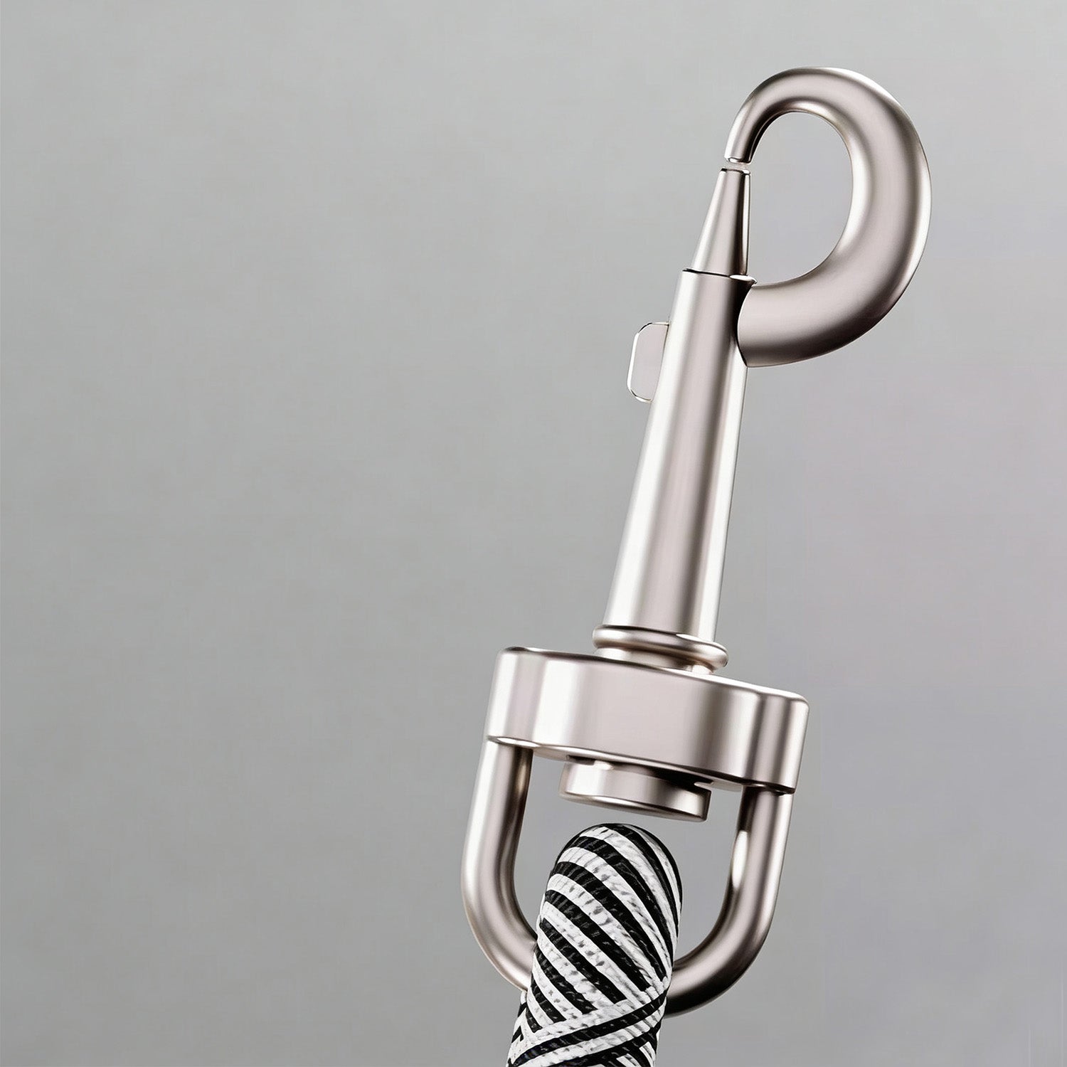 Close-up of strong rotating metal clip on green rope dog leash