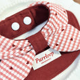 Load image into Gallery viewer, Deep red bow dog collar bandana with snap-button closure styled on plate
