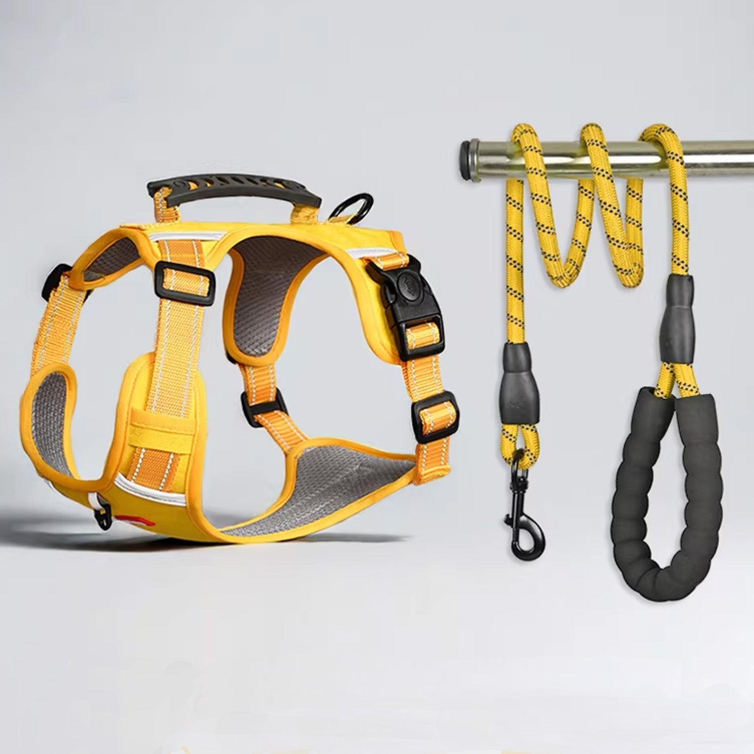 Yellow tactical dog harness and leash set laid flat showing all adjustment points and attachment hardware