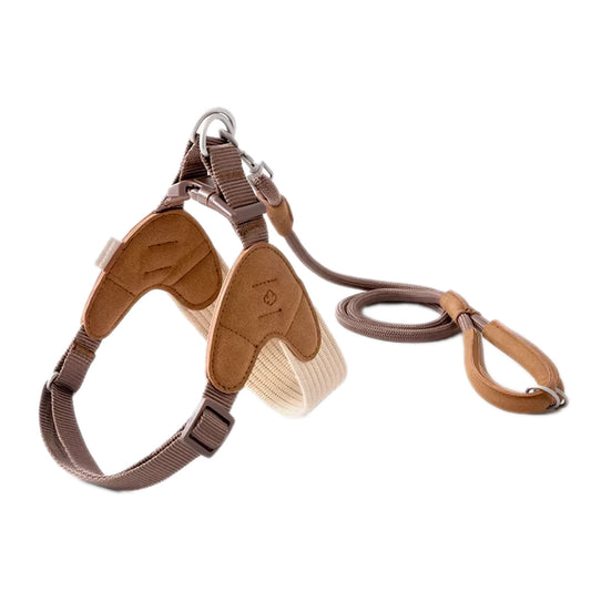 Brown V-shaped dog harness and leash set on white background