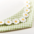 Load image into Gallery viewer, Side view of green daisy pet bandana showing cotton-linen fabric texture and embroidered floral trim
