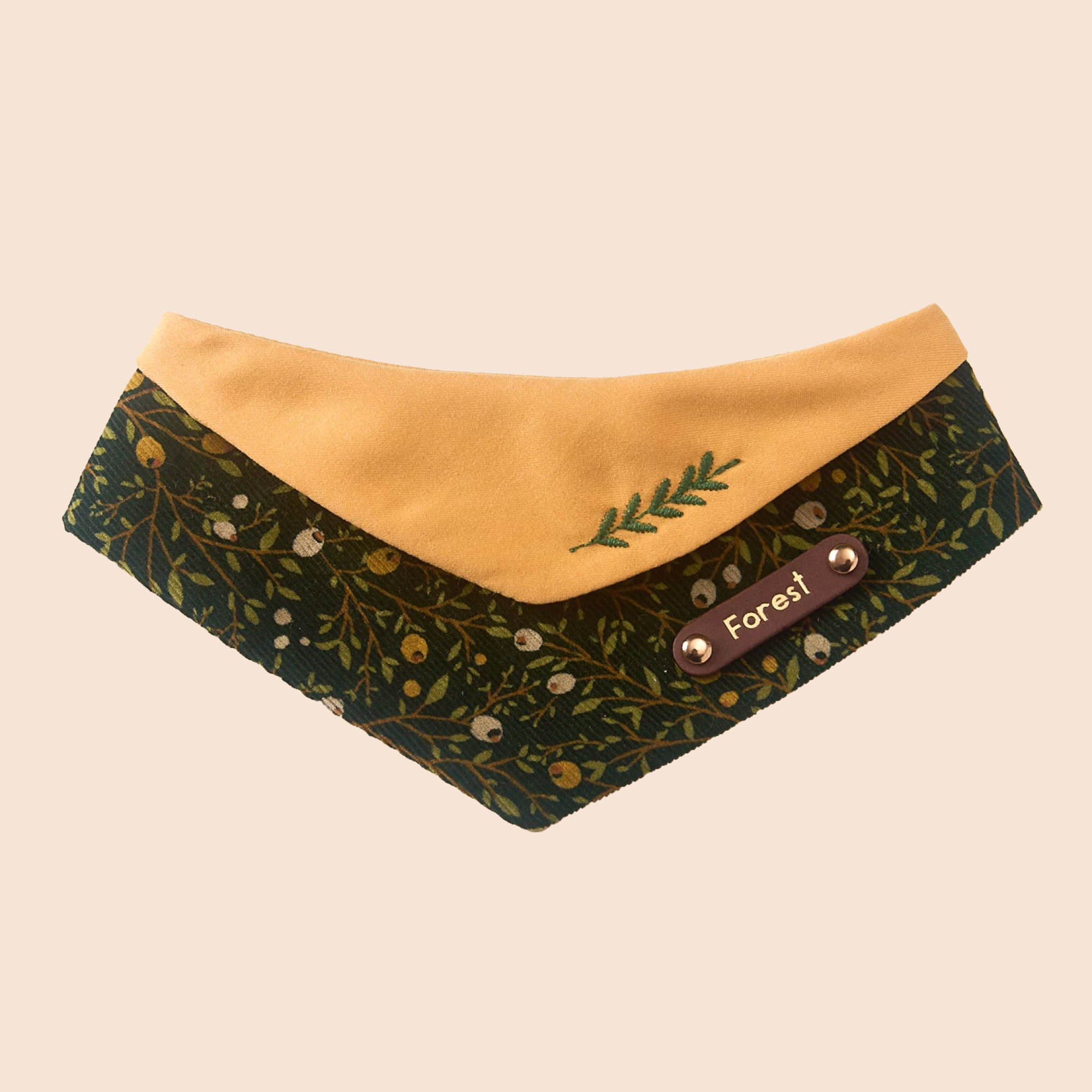 Cottagecore forest pet bandana with woodland berry print, mustard cotton lining, and custom leather name plate on soft beige background