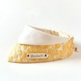 Load image into Gallery viewer, Side angle of gold floral pet bandana showing jacquard texture and personalized engraved name tag
