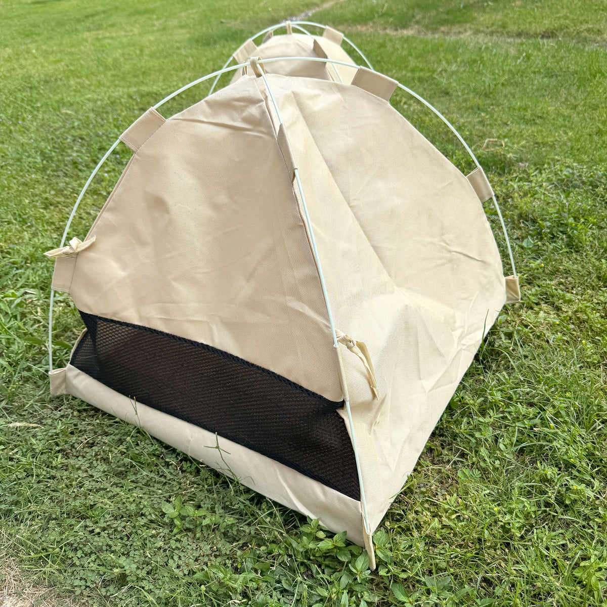 Gravipaw cat tent bed on grass showing the lightweight camping-tent style design