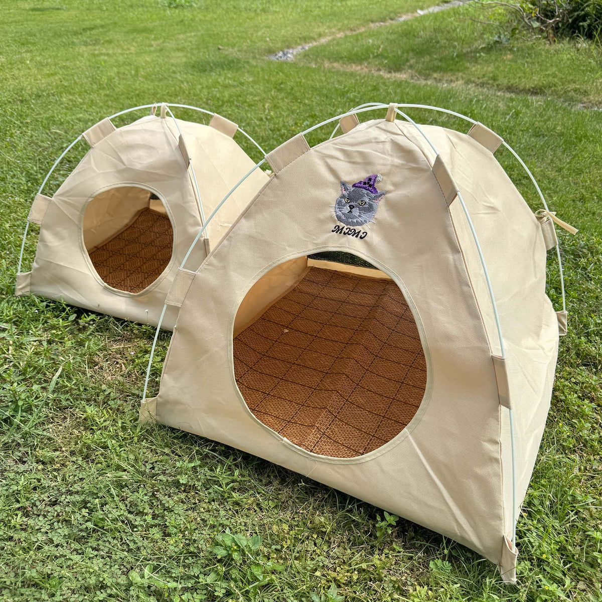 Gravipaw cat tent bed outdoors on grass with custom embroidered pet portrait on the entrance