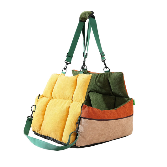 Multicolored pet carrier with green, yellow, brown, and orange sections on a beige background