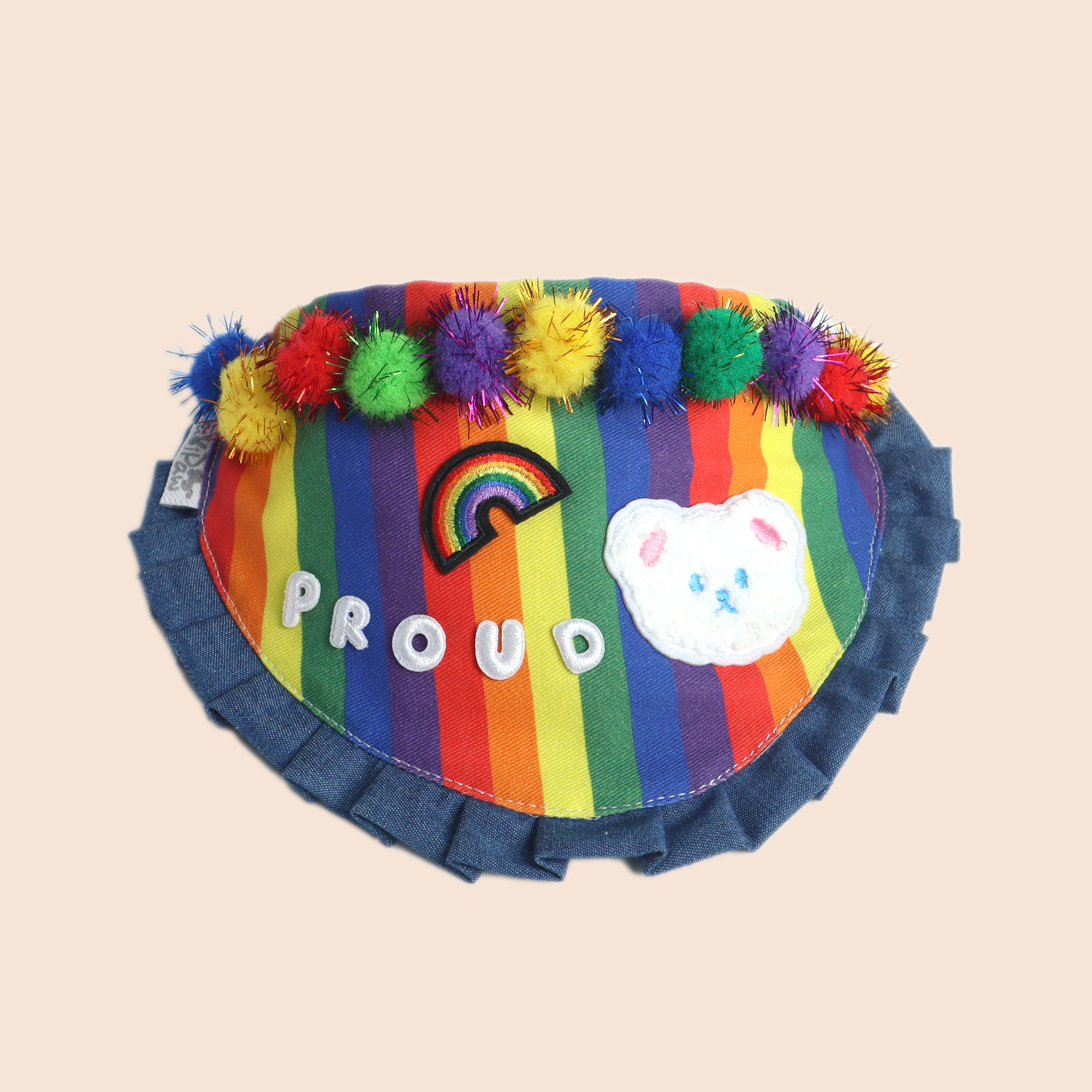 Personalized Pride pet bandana with rainbow stripes, multicolor pom-poms, denim ruffle, and embroidered "PROUD" text